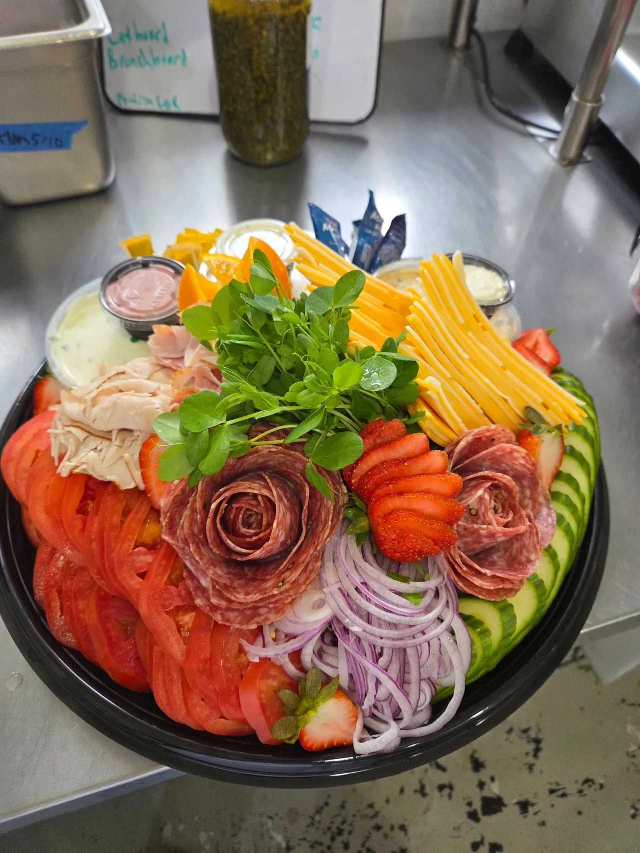 B's Bagels Brunch Board — turkey, ham, soppressata, cheddar, tomato, cream cheeses and a salami rose