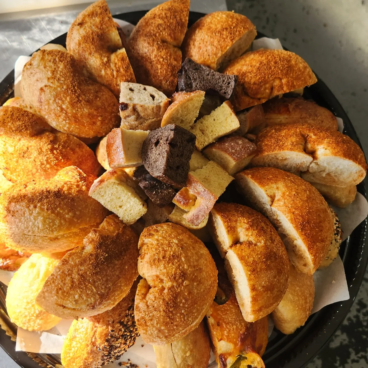 A platter of assorted B's Bagels — halved, sliced and ready to serve